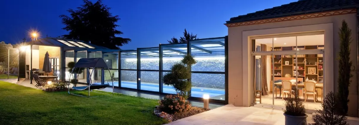 Abri de piscine haut éclairé à la tombée de la nuit