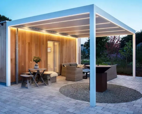 Pergola Brustor en aluminium installée sur une terrasse avec salon de jardin.