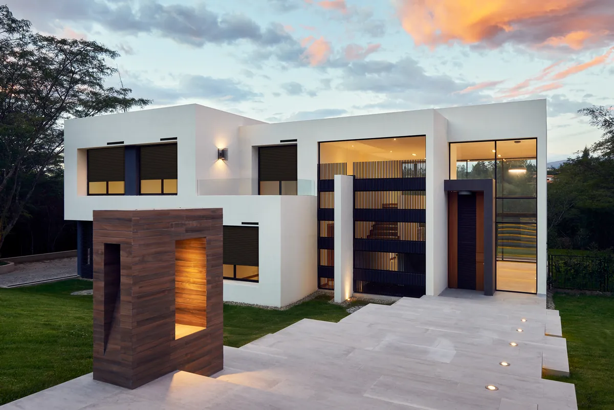Maison contemporaine équipée de volets roulants motorisés, le soir