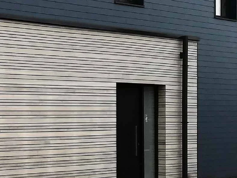Porte d’entrée Finstral FIN-Door sur une maison à bardage bois