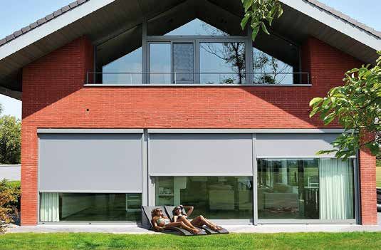 Screens ZIP Brustor baissés devant les fenêtres d'une maison en brique rouge